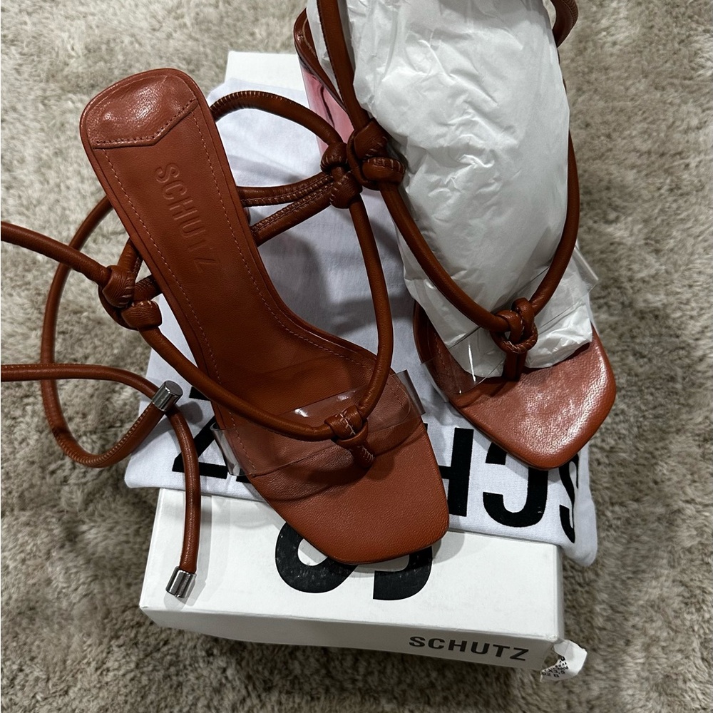 SCHUTZ caramel and clear strap block heel sandals.